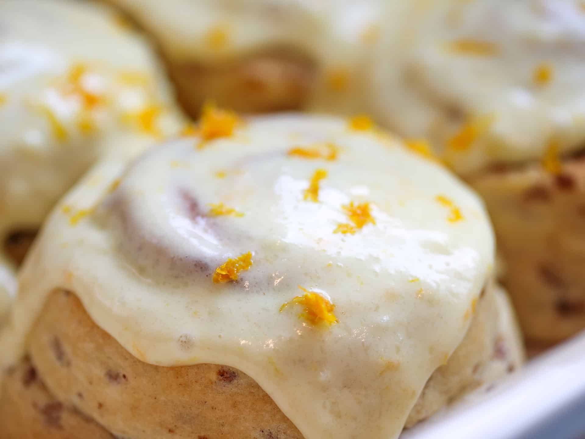Cinammon roll with orange cream cheese frosting
