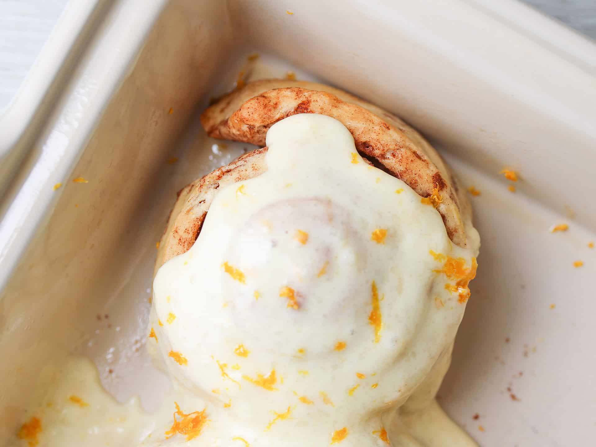 Cinammon roll with orange cream cheese frosting