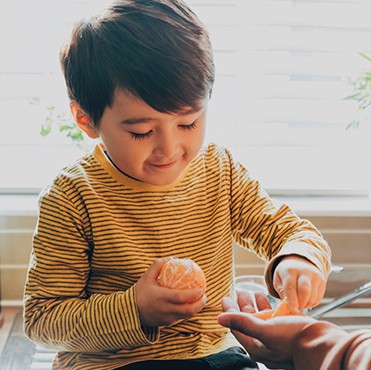Child eating an orange